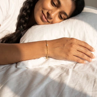 Thumbnail for Heart Bond Matching Bracelet Set in Gold — worn on her wrist on a lazy morning in bed