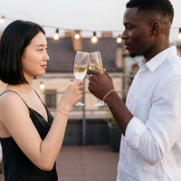 Thumbnail for Heart Bond Matching Bracelet Set in Gold — worn by a couple toasting with champagne