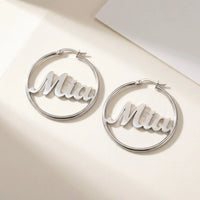 Thumbnail for Custom Name Hoop Earrings in Silver, studio packshot of the pair on a plain background | SKU: name-hoop-silver-30-mm