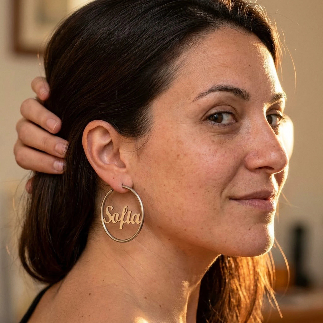 Custom Name Hoop Earrings in Silver worn on the ear, close-up on a model | SKU: name-hoop-silver-30-mm