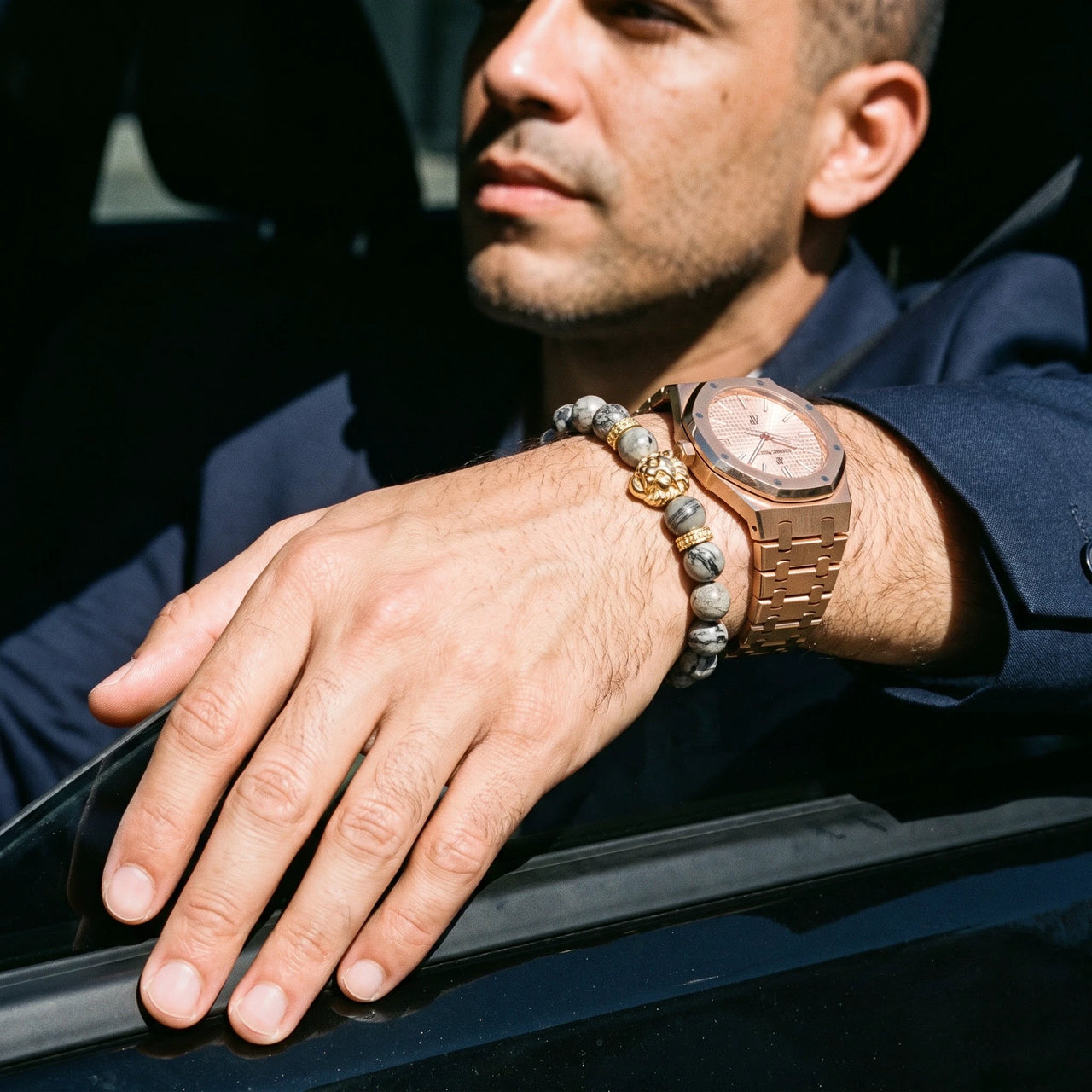 Gold Lion & Grey Stones Bracelet – worn next to a luxury watch | Brother & Sisters | SKU: 20866222-gold-XS-14-15, 20866222-gold-S-16-17, 20866222-gold-M-18-19, 20866222-gold-L-20-21, 20866222-gold-XL-22-23