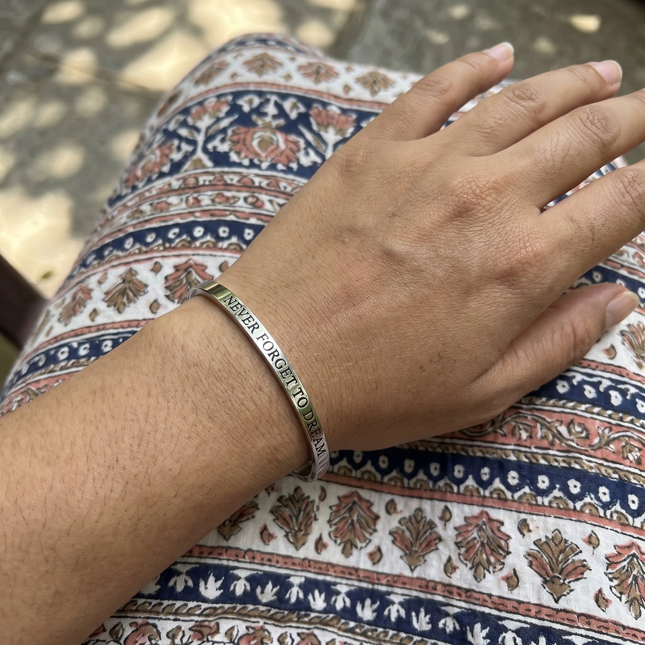 Never Forget To Dream bracelet in silver worn, showing its real size | SKU: nftd-wg