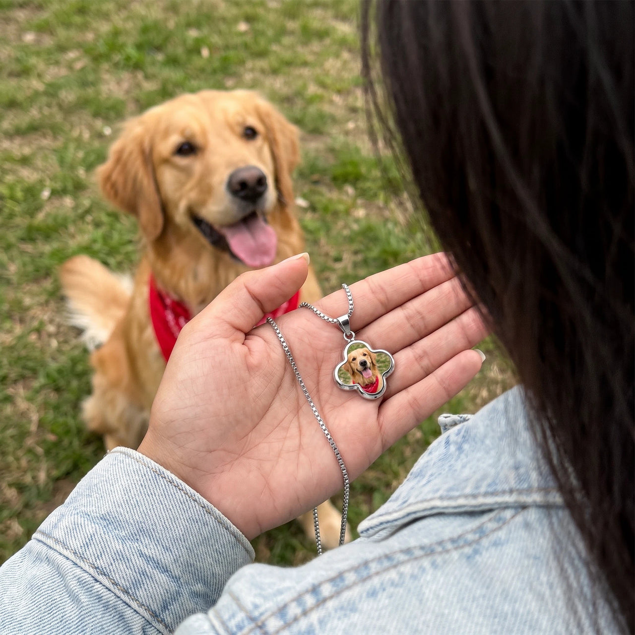 Customer photo: the silver clover photo necklace with her dog's photo, her golden retriever in the background | SKU: TPH-CLVN-SILVER