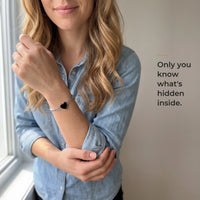 Thumbnail for Woman wearing the silver bracelet with its black heart charm, only she knows the photo inside | SKU: TPH-HRTB-SILVER